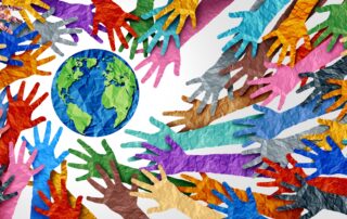 multi-colored cut out crumpled paper hands reaching towards a graphic of the earth which is also made with crumpled then smoothed out paper. Blue earth with green continents.