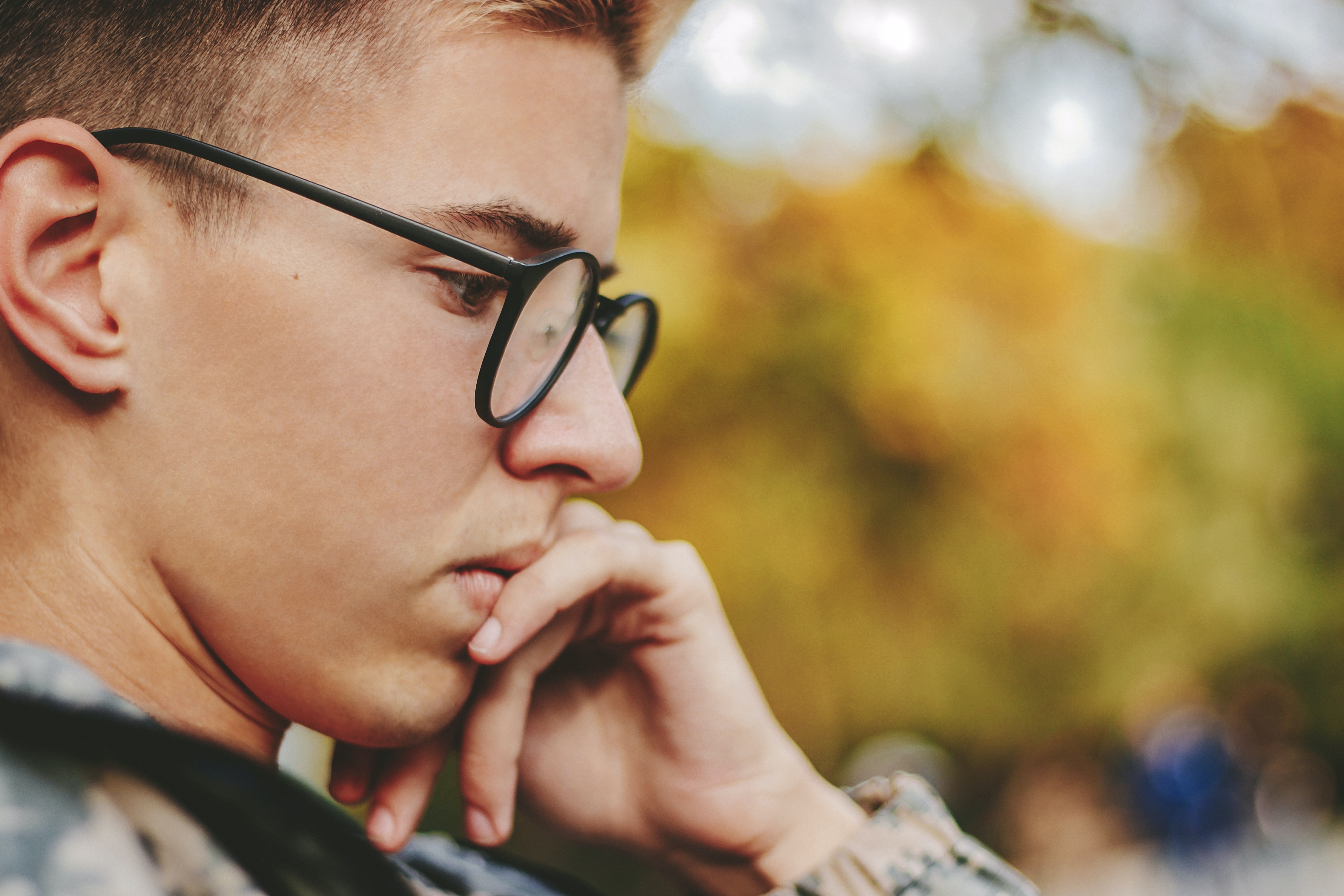 Photo of a young teen or adult male profile face who appears to be reading or thinking. Hes wearing glasses, and has his chin resting on one hand. Reciprocal Teaching with top learn strategies speaker Susan Fitzell, M.Ed., CSP